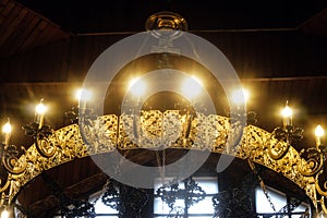 Chandelier in Russian Orthodox Church with crucifix and electric lamps