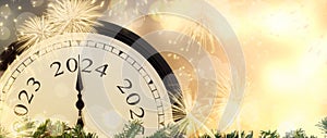 Change from 2023 to 2024 New Year\'s Eve clock on magic fireworks background.