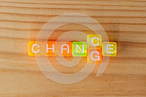 CHANGE & CHANCE text with color letters cubes on wooden background. Minimal business concept