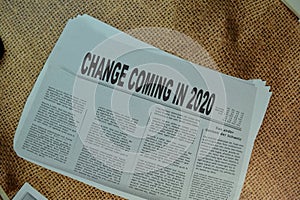 Change Coming in 2020 text in headline isolated on Brown burlap laying on table. Newspaper concept