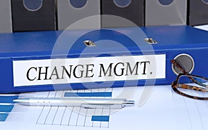 Change Management, blue binder with text in the office