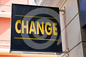 Change means in french text yellow exchange money office on wall entrance facade