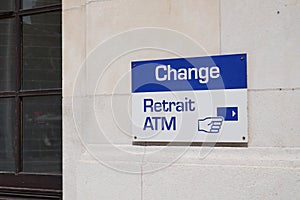 Change retrait atm means in french text exchange money office and square shape ATM sign in wall building bank agency