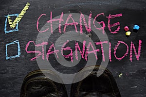 Change or Stagnation written with color chalk concept on the blackboard photo