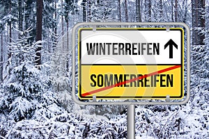 Change summer tires to winter tires street sign. Von Sommerreifen auf Winterreifen wechseln Schild.