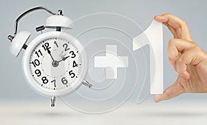 Change time. Spring forward, on a gray background. A white alarm clock indicates that the time has been moved forward an