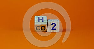 Change to fuel cell vehicles. Fliped cube, changes the expression CO2 to H2. Beautiful orange background. Ecological concept. Copy