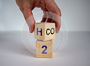 Change to fuel cell vehicles. Hand flips a cube and changes the expression CO2 to H2. Beautiful white background. Ecological