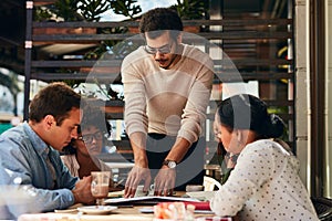 Change up your workspace and improve productivity. designers having a meeting at a coffee shop.