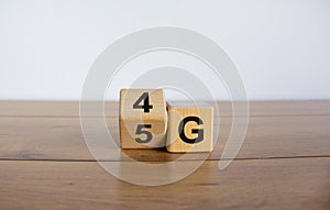 Change wooden block from 4G to 5G. Technology, network, communication concept. Beautiful wooden table. White background, copy