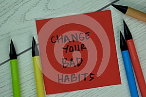 Change Your Bad Habits write on sticky notes isolated on Wooden Table