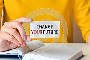 Change your future written on a paper card in woman hand