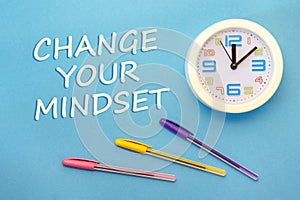 CHANGE YOUR MINDSET - lettering on a blue background and clock