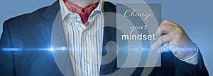 CHANGE YOUR MINDSET message on the card shown by a man in a gray suit