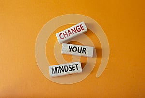 Change your mindset symbol. Concept words Change your mindset on wooden blocks. Beautiful orange background. Business and Change