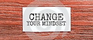 Change Your Mindset text on the piece of paper on the red wood background