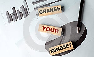 CHANGE YOUR MINDSET text on wooden block on chart background