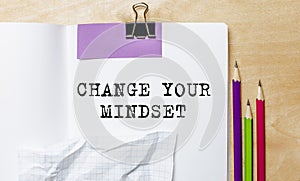 CHANGE YOUR MINDSET text written on a paper with pencils on the desk in the office