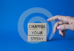Change your story symbol. Concept word Change your story on wooden blocks. Beautiful blue background. Businessman hand. Business