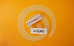 Changes ahead symbol. Wooden blocks with words Changes ahead. Beautiful orange background. Business and Changes ahead concept.