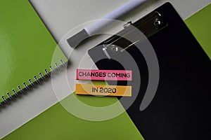 Changes coming in 2020 text on top view office desk table of Business workplace and business objects