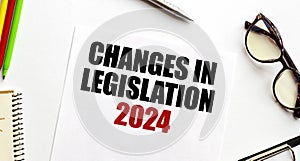 CHANGES IN LEGISLATION 2024 words on paper with pen glasses and pencils
