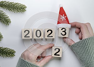 Changing of 2022 to 2023 on wooden block cube for preparation new year change and start new business target strategy concept