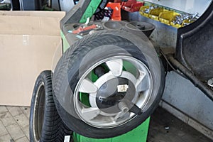 Changing car tire in an auto repair shop