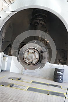 Changing car tire in an auto repair shop