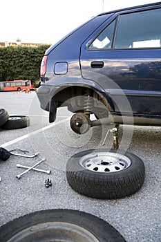 Changing car tires at parking lot