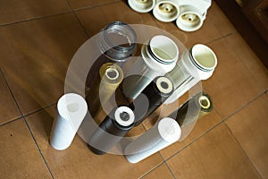 Changing filters in your home water purification system. Clean and used filters in comparison. Waterwater is very dirty