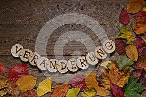 Changing leaves on wood with letters VERÃ„NDERUNG