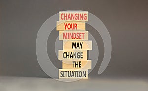 Changing mindset symbol. Concept words Changing your mindset may change the situation on wooden blocks on a beautiful grey table