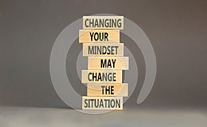 Changing mindset symbol. Concept words Changing your mindset may change the situation on wooden blocks on a beautiful grey table