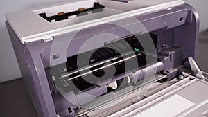 Changing of office printer cassette. Man hand takes toner cartridge from laser print machine