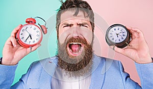 Changing time zones affect health. Does changing clock mess with your health. Man bearded hipster hold two different