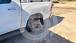 Changing tires. Jacked up 4x4 car due to a flat tire in the stone desert of Namibia