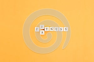 Changing the word made up of cubes with letters, turning Fitness word into Fatness