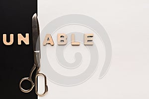 Changing word unable into able with scissors