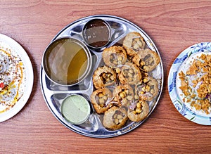 channa papri chat masala, dahi baray and pani puri or gol gappay with raita, sweet sauce and spicy water served in dish isolated