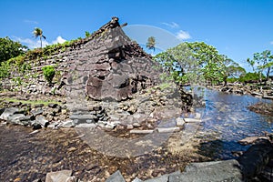 A channel and town walls in Nan Madol - prehistoric ruined stone city. Pohnpei, Micronesia, Oceania.