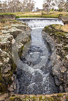 Channeled water flowing from a weir