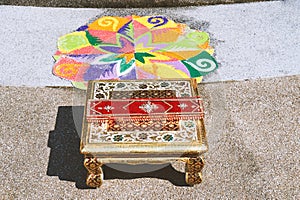 Colorful rangoli art and chantry on the floor during indian wedding ceremony photo