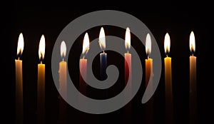 Chanukah candles glowing in the dark photo