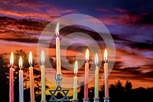 Chanukah Menorah in the Jewish festival of lights beautiful sky with cloud sunset photo