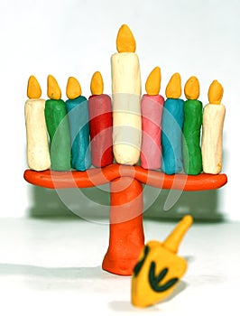 Chanukia from plasticine of different colors. Hanukkah. Hebrew Dreidel. Sevivon. Jewish holiday