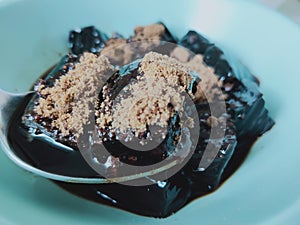 Chao Kuai Thai dessert served with syrup sprinkled with brown sugar