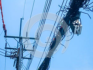 Chaos of cables and wires on an electric pole, Thailand. Wire and cable clutter