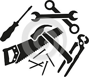 Chaos of working tools - screwdriver, wrench, hammer, saw, plier, nails photo