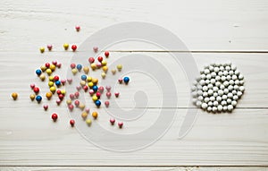 Chaotic colorful balls and organized white balls. Conceptual of